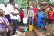 Celebrating water is flowing to one tap stand in Mekume with funders
