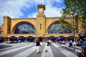 Kings Cross Station in London-- a giant train station with large amounts of glass in its double-domed structure